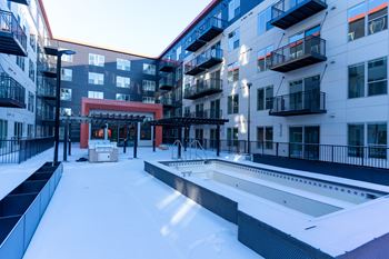 A snow-covered courtyard surrounded by apartment buildings.
